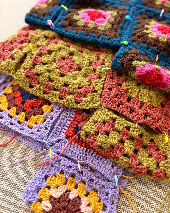 Stack of hand crocheted granny square balaclavas