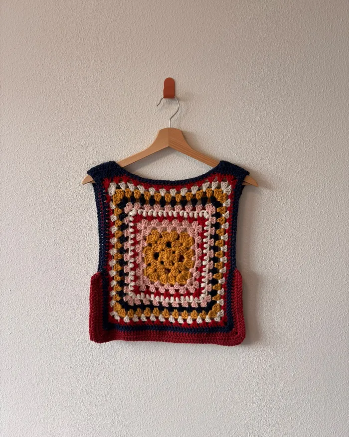The Maresia vest hanging on a wall, one side