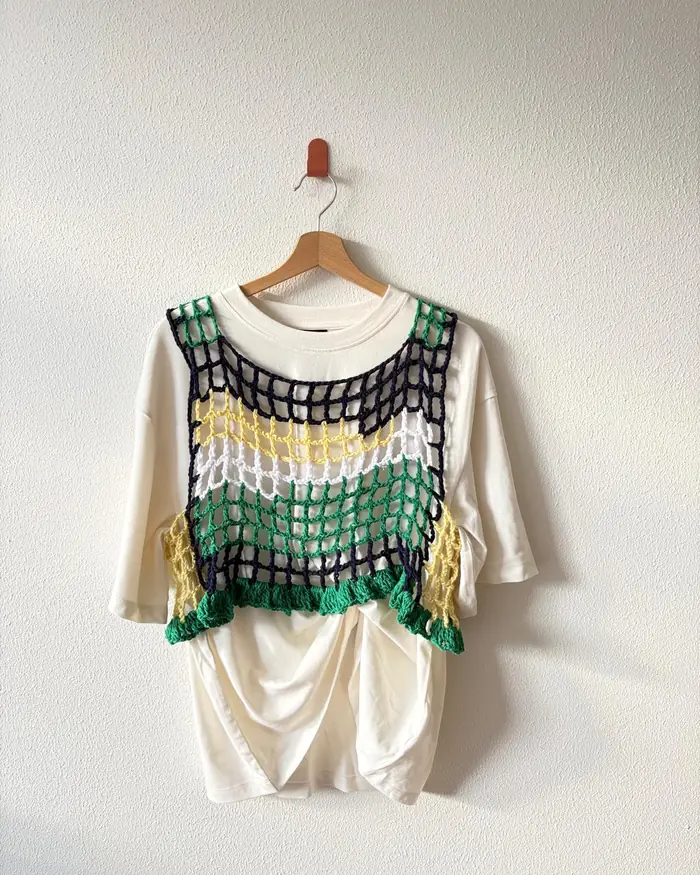 Open mesh crochet top layered over a white tee