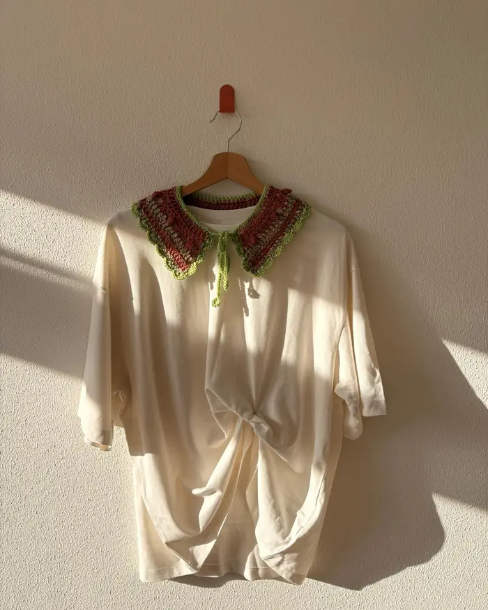 Crochet collar on a cream blouse in raking daylight