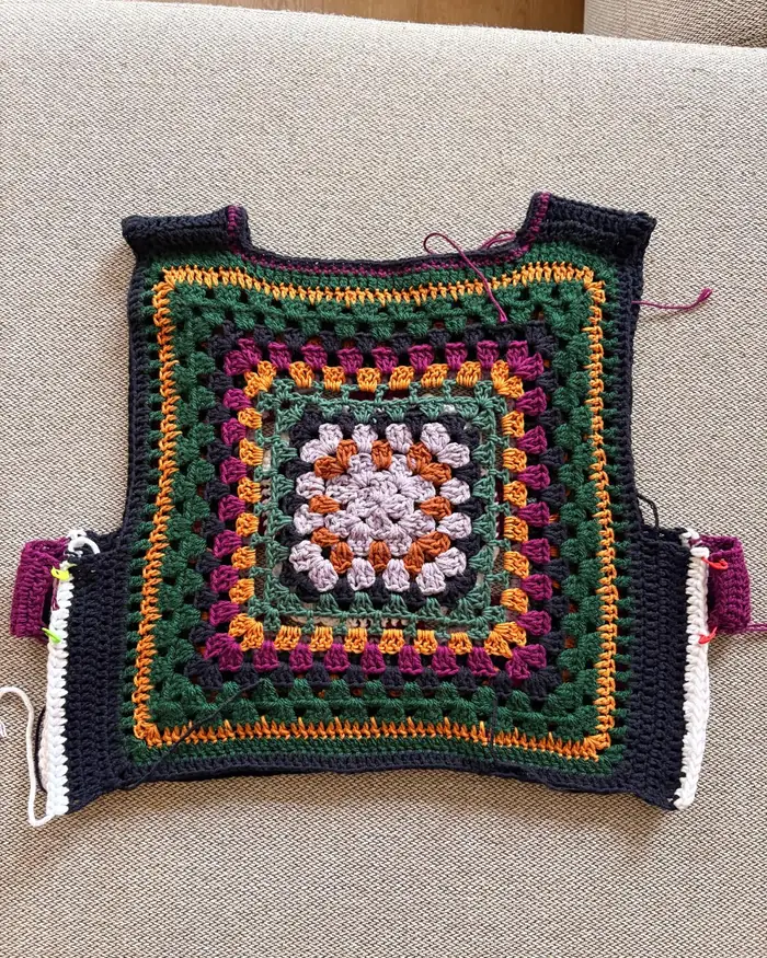 Granny square vest laid flat, still being made