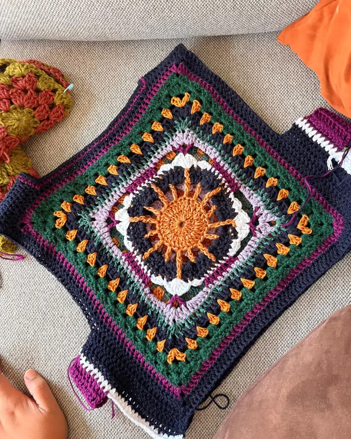 Granny square vest laid flat on linen