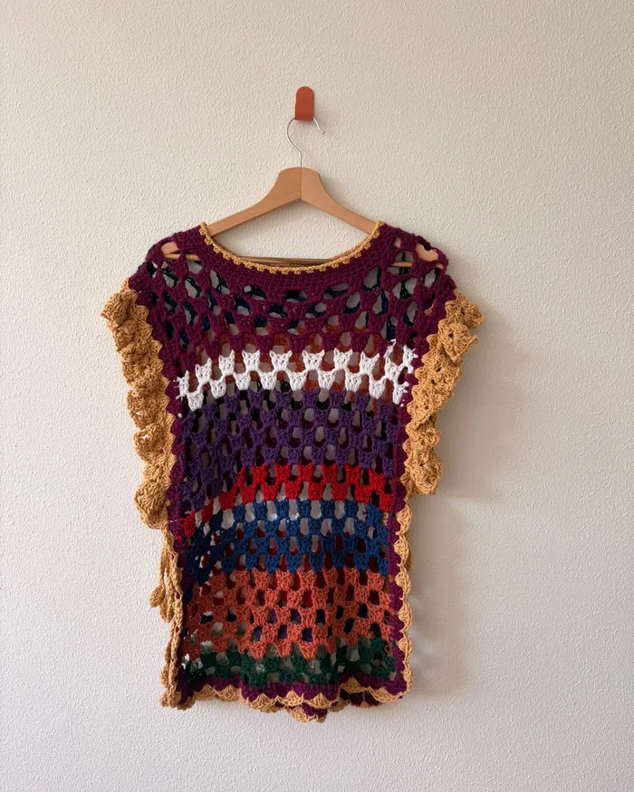 The La Ursa tunic hanging on a wall, one side